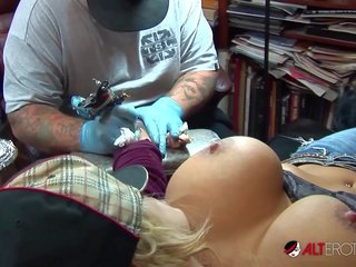 Shyla Stylez gets tattooed while playing with her tits